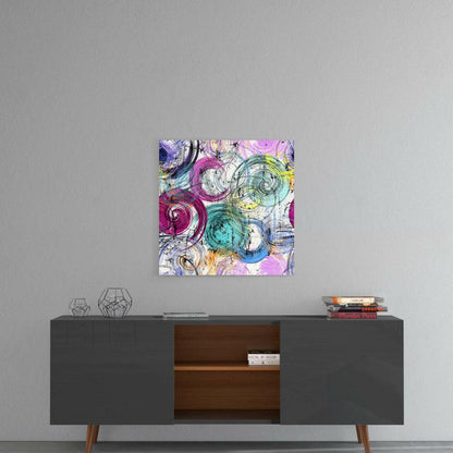 Colorful abstract snail shell glass art hanging above a mid-century modern console table in a minimalist interior setting.