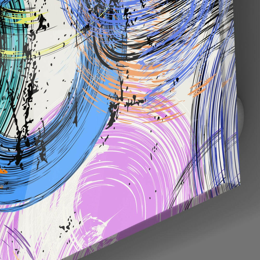 Angled perspective of glass wall art showing swirling concentric patterns in pink, blue, orange, and black with silhouetted figures.