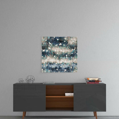 Abstract blue, teal, and cream glass wall art hung above a mid-century modern credenza with geometric decor and stacked books.