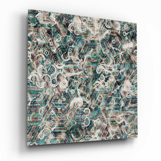 Angled perspective of glass wall art displaying layered teal, cream, and burgundy abstract circular patterns on textured linen background.