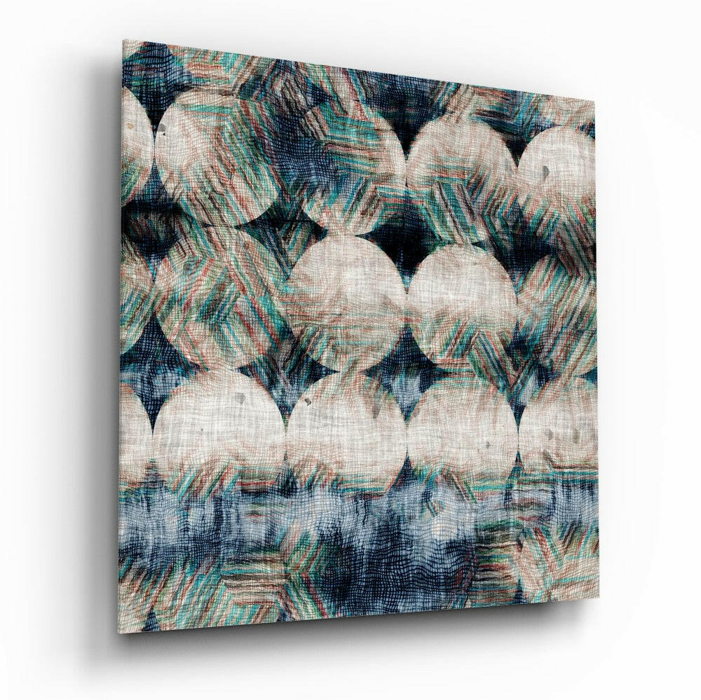 Close-up angled view of textured glass wall art with cream circles and teal, navy, and rust striped patterns on linen-like surface.