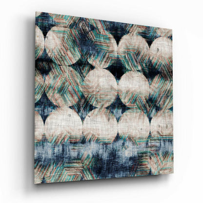 Close-up angled view of textured glass wall art with cream circles and teal, navy, and rust striped patterns on linen-like surface.