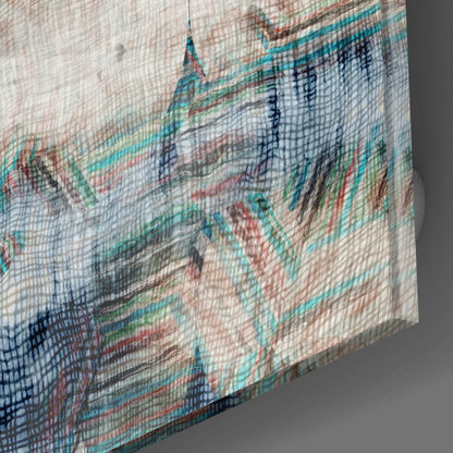 Close-up angled view of textured glass wall art showing layered abstract architectural imagery in turquoise, coral, navy, and cream tones.