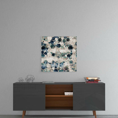 Square glass wall art with blue and teal circular microscope pattern on cream background, hung above mid-century modern console table.