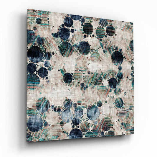 Angled view of textured glass wall art displaying dark navy and teal circular microscopic forms with linear patterns on cream linen background.