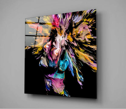 Colorful abstract paint explosion in magenta, gold, blue, and pink bursting from center on black glass panel mounted at angle.