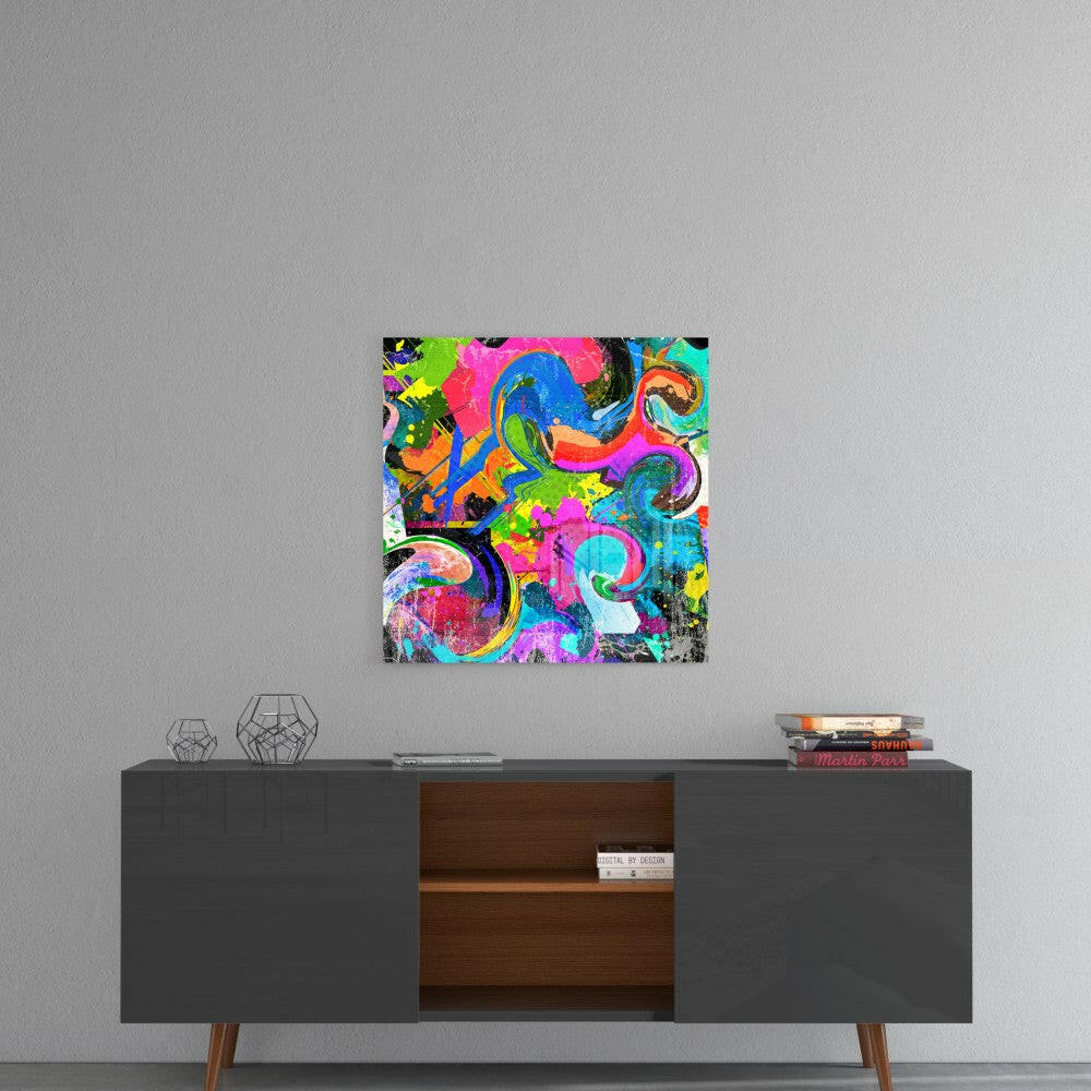 Vibrant multicolored abstract glass art with swirling neon pink, blue, green, and orange patterns displayed on gray wall above dark credenza.