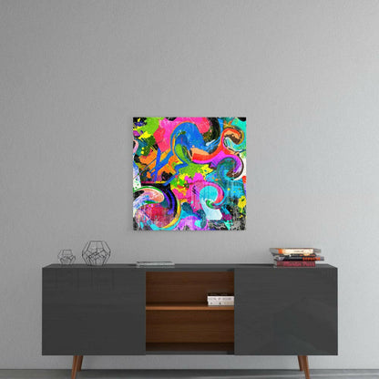 Vibrant multicolored abstract glass art with swirling neon pink, blue, green, and orange patterns displayed on gray wall above dark credenza.