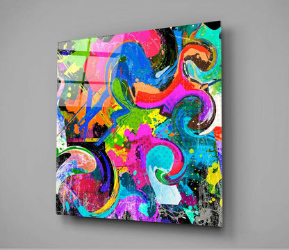 Vibrant abstract glass wall art featuring neon swirls and splatter patterns in pink, blue, green, and yellow against a gray background.