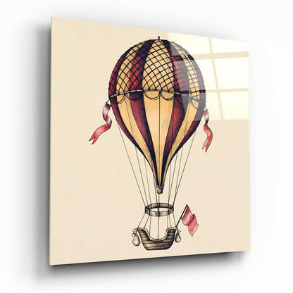 Vintage-style illustration of a red and cream hot air balloon with basket and trailing ribbons on cream canvas, displayed at an angle.