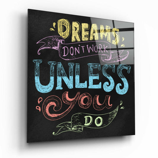 Square glass wall art with colorful hand-drawn text on black background reading "Dreams don't work unless you do" with decorative ribbon flourishes.
