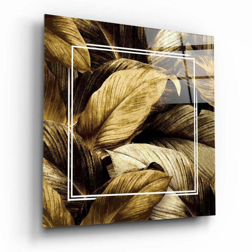 Square glass panel with white border frame displaying gold and brown layered leaf textures in close-up view.