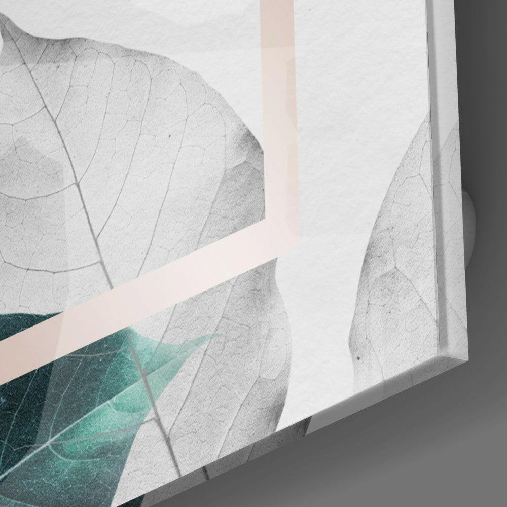 Close-up angled view of glass wall art showing translucent gray leaves with teal accents and beige stripe detail.