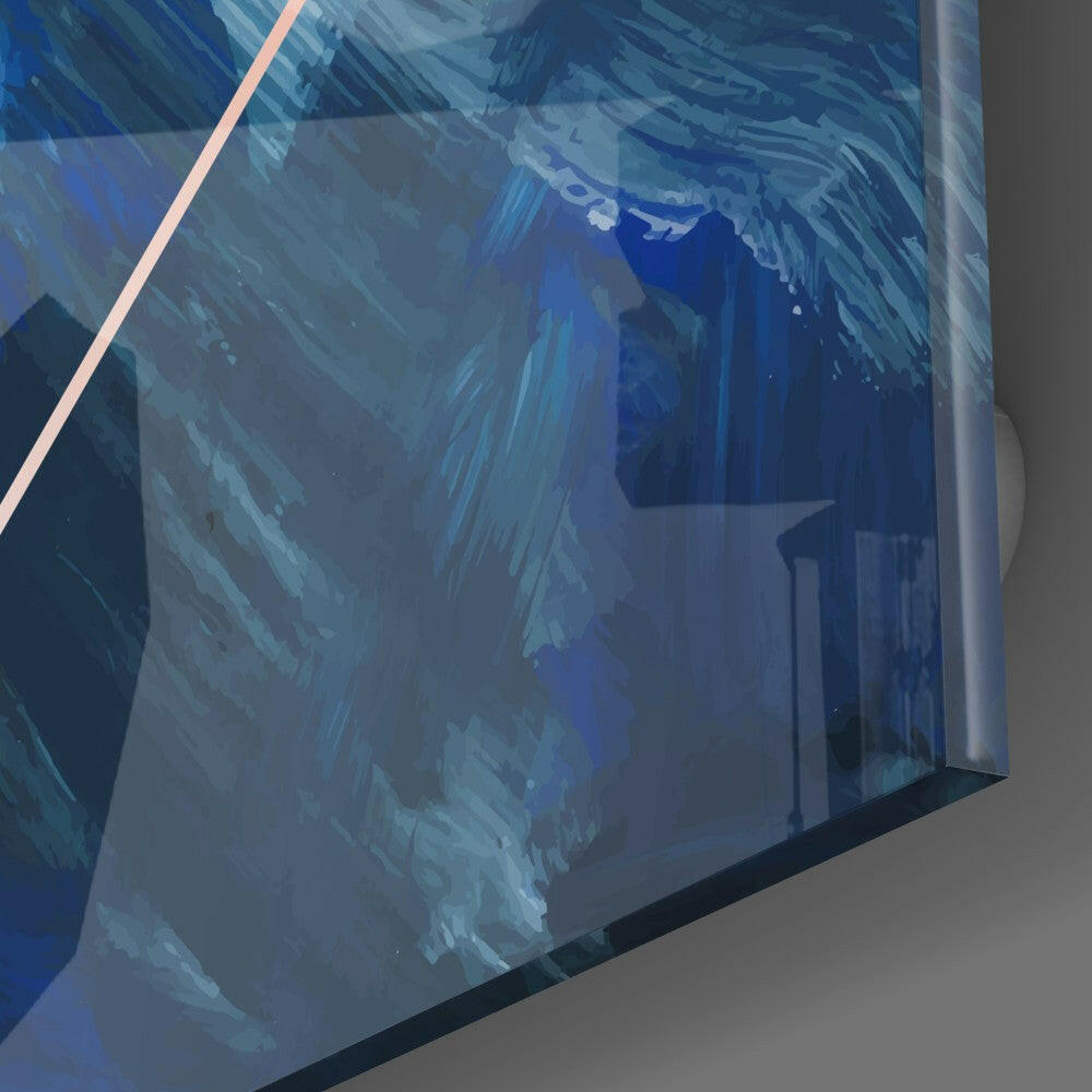 Close-up angled view of glass wall art with blue and teal brushstroke patterns and pink diagonal line, mounted on gray wall.