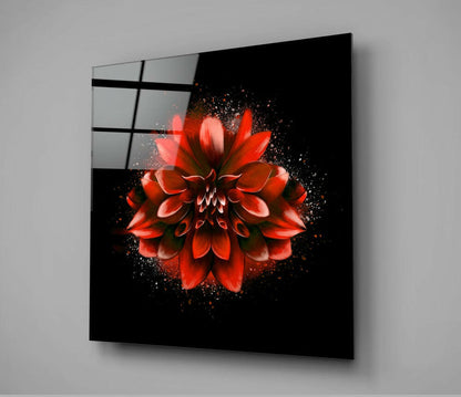 Red lotus flower with particle explosion effect on black glass panel mounted at angle, showing grid pattern on left edge.
