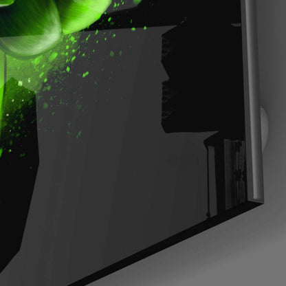 Green Lotus Glass Wall Art mounted on wall, showing bright green glowing lotus design with particle effects against dark background, side angle view.