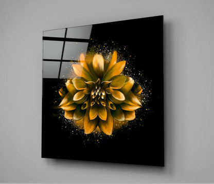 Yellow and gold lotus flower with particle effects on black glass mounted on gray wall, shown at angle with grid pattern visible on left edge.