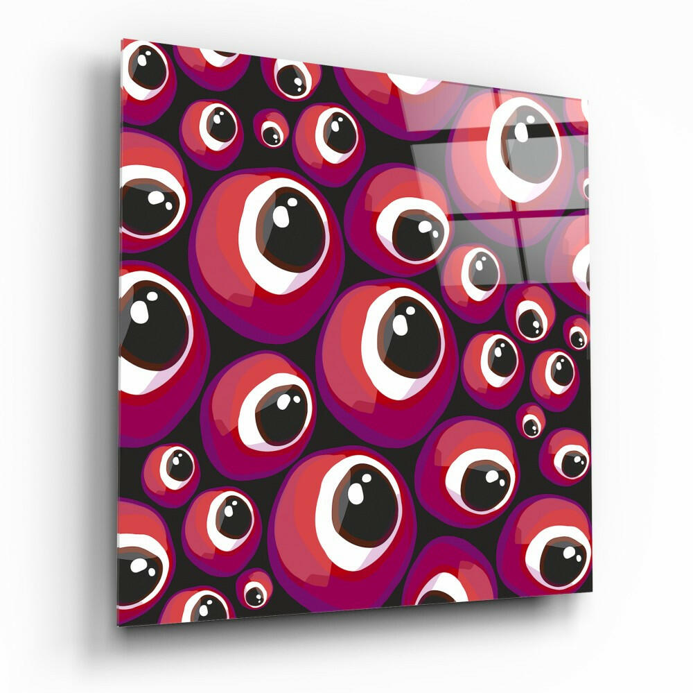 Angled perspective of red and purple evil eye beads glass wall art panel mounted on dark background, displaying glossy layered circular design with white and black pupil details.