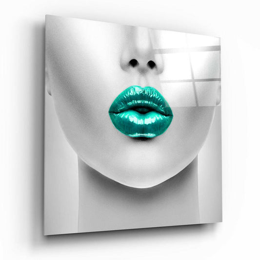 Close-up of monochrome face with vibrant turquoise glossy lips on frosted glass panel, angled three-quarter view.