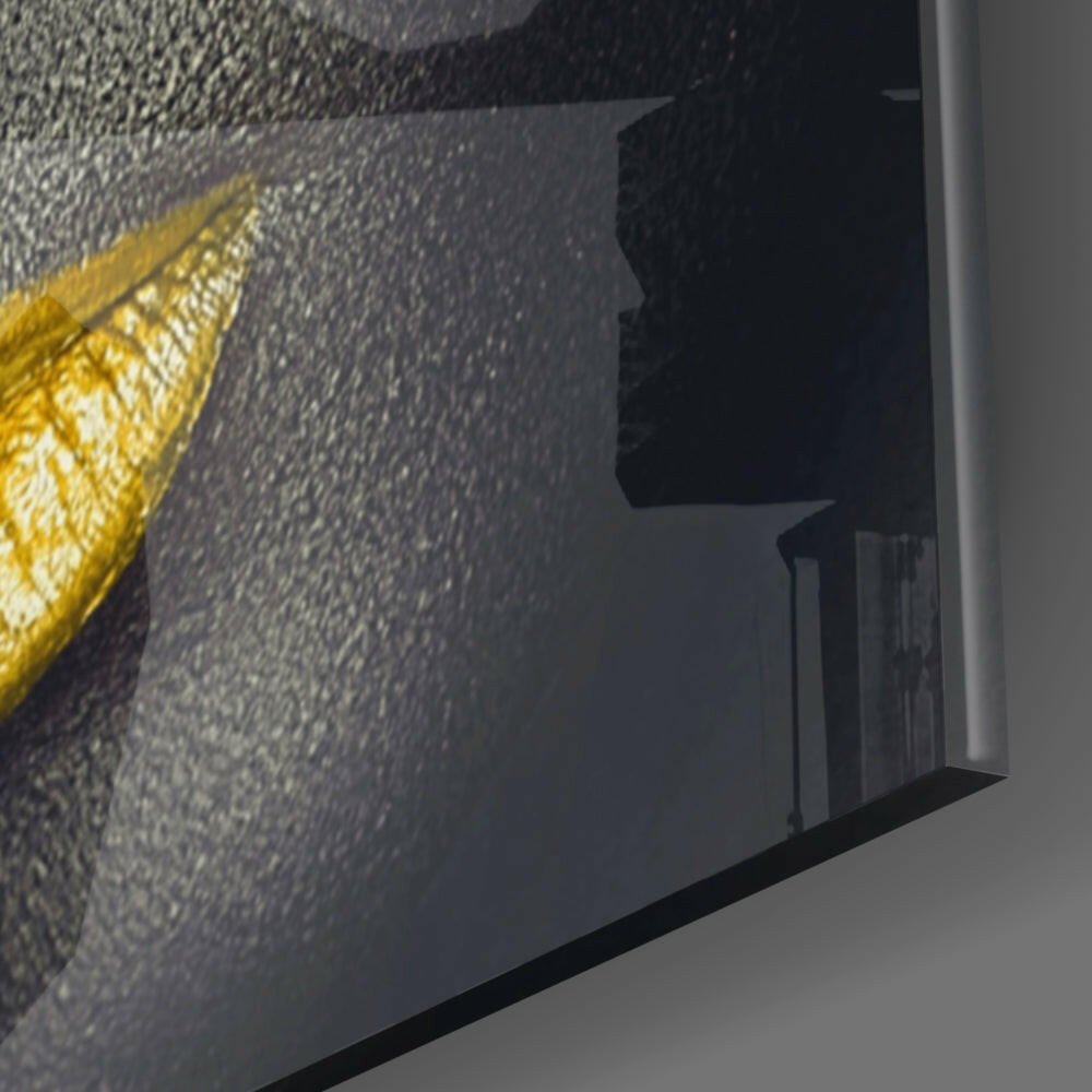 Close-up angled view of yellow lashes glass wall art mounted on textured gray wall, showing side profile and mounting hardware.