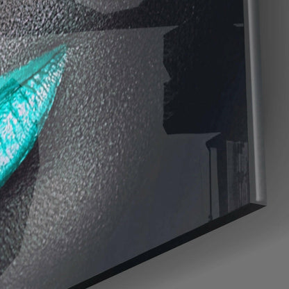 Side angle view of turquoise lashes design on textured glass wall art panel mounted on white wall.