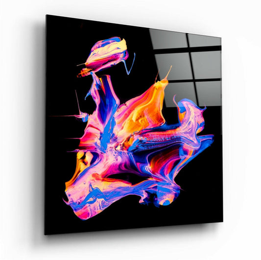 Angled perspective of vibrant neon paint pour glass art with magenta, yellow, and blue swirls on black background.