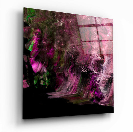 Angled perspective of glass wall art featuring vibrant magenta and green swirling abstract patterns with black background.