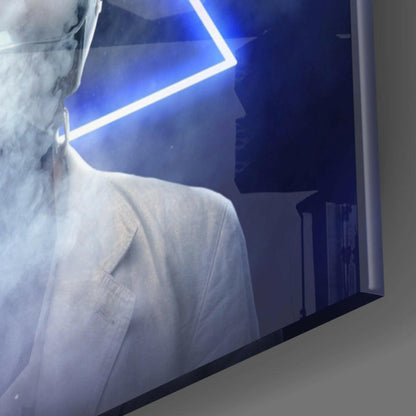 Close-up angled view of glass wall art with blue neon geometric lines and silhouetted figure against dark background.