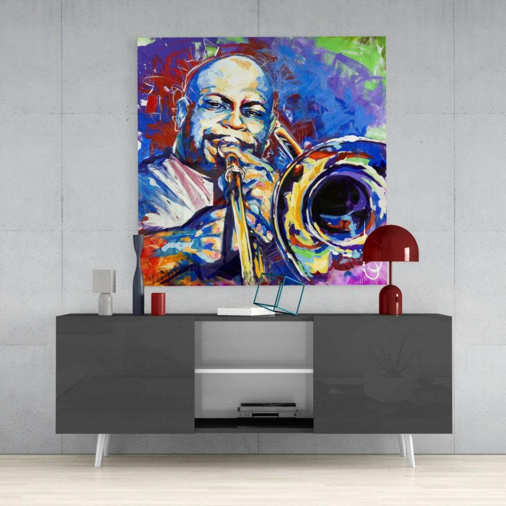 Colorful pop art trombone glass wall art hung above gray modern console table with red decorative accessories.