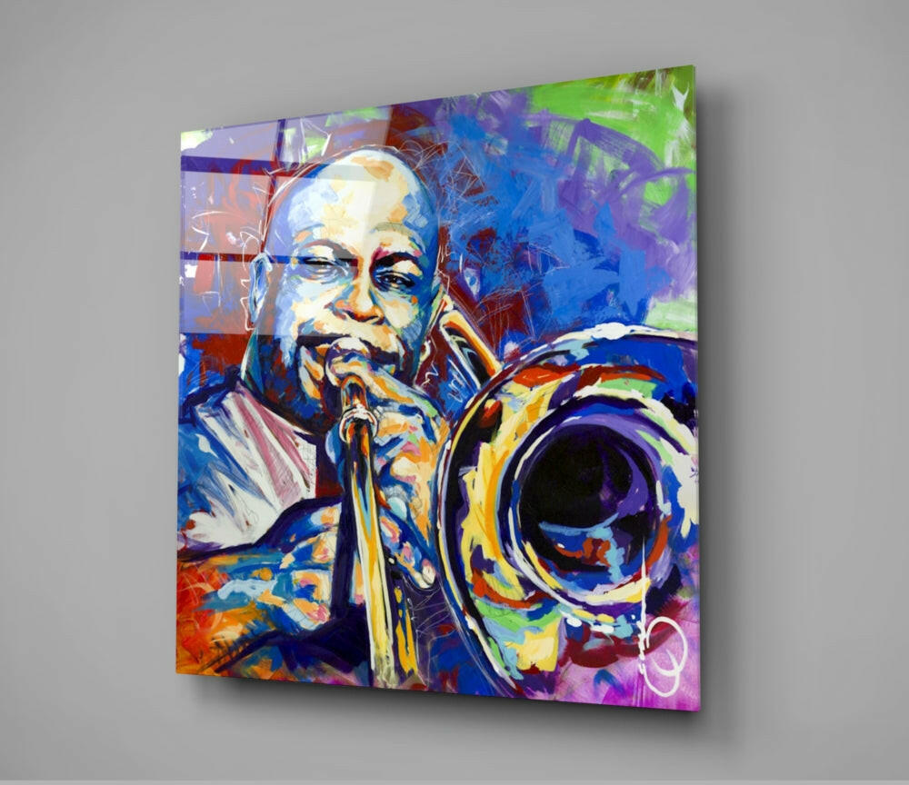 Colorful glass wall art depicting a musician playing trombone with vibrant blue, purple, green, and orange abstract background, displayed at an angle against gray wall.