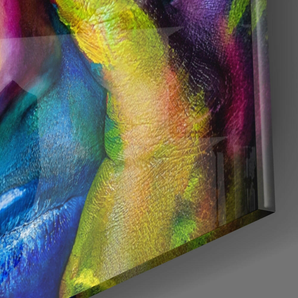 Close-up angled view of colorful glass wall art showing blue, yellow, green, and purple painted sections with textured surface detail.