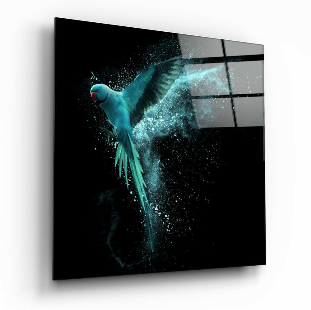 Turquoise parrot with spread wings against black background on illuminated glass panel with grid pattern, displayed at angle.