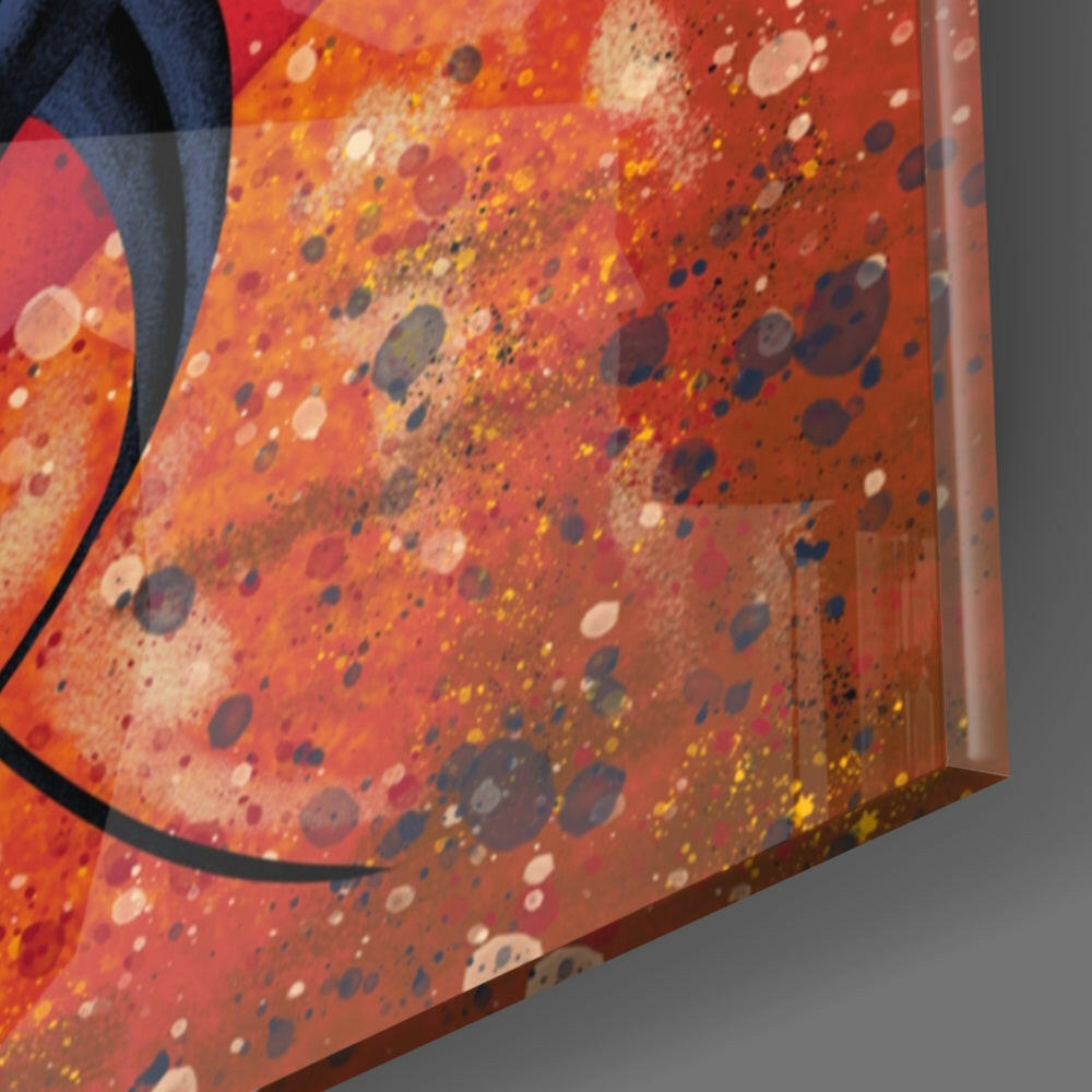 Close-up angled view of red and orange glass wall art with multicolored spattered dots and a black curved line detail.