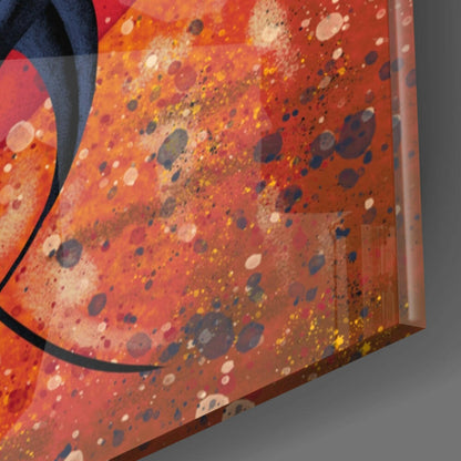 Close-up angled view of red and orange glass wall art with multicolored spattered dots and a black curved line detail.