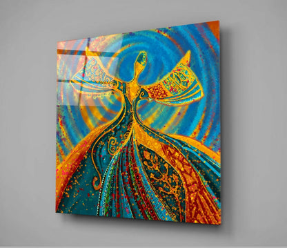 Colorful glass wall art displaying an ornate golden figure with outstretched arms against vibrant blue and orange swirling background, angled perspective view.