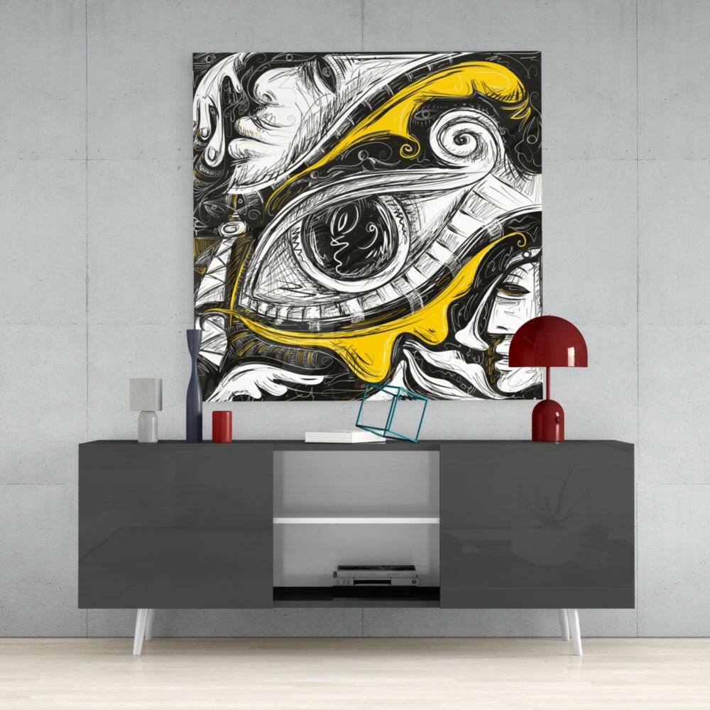 Black and white line art with yellow accents depicting an ornate eye, displayed above a gray media console with red dome lamps in a modern interior setting.
