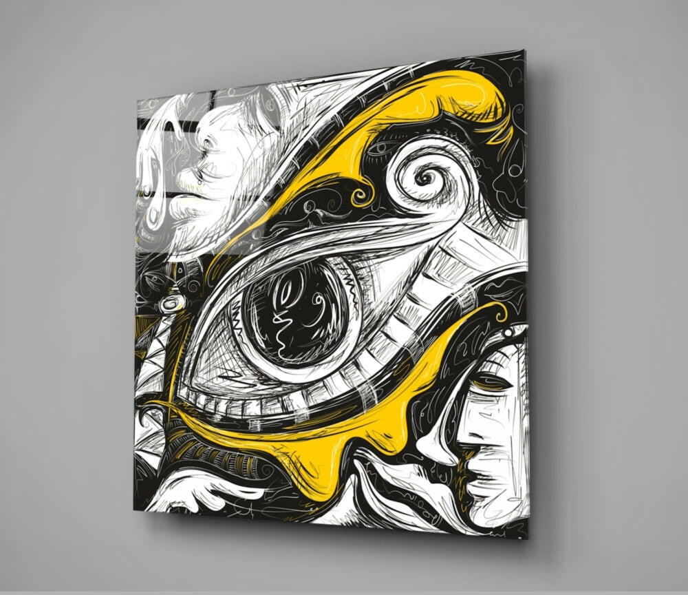 Square glass wall art displaying an ornate eye illustration in black ink with yellow accents, mounted on gray wall with shadow visible.