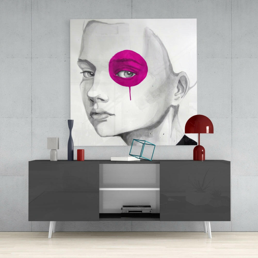 Modern interior display featuring a grayscale portrait with a bright magenta circular design, mounted above a dark console table with red accents.