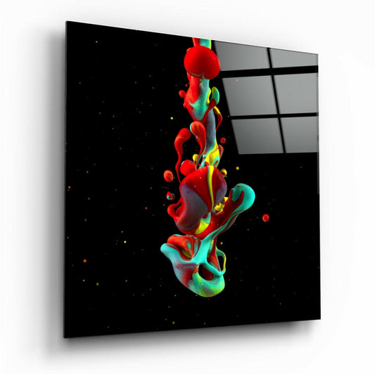 Angled perspective view of glass wall art displaying vibrant red and teal paint splashes against black background, mounted on white wall.