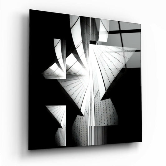 Black and white glass wall art displaying upward-angled modern skyscrapers with strong geometric shadows and architectural lines.