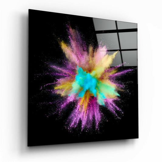 Angled perspective view of colorful powder explosion glass art with teal, yellow, pink and purple particles on black background, mounted on wall.