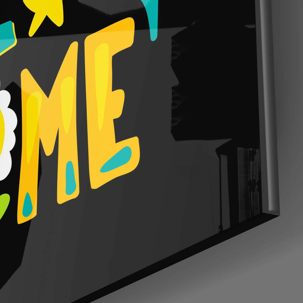 Close-up angled view of yellow "WAKE" text with cyan accents on dark glass wall art panel.
