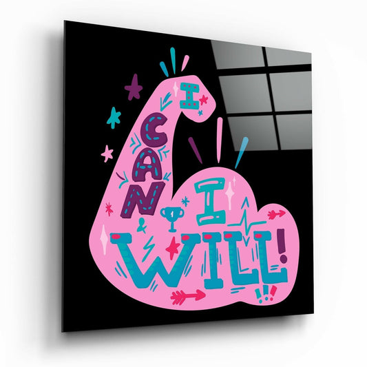 Pink pear-shaped glass wall art with teal and purple text reading "I Can I Will" surrounded by decorative stars and flourishes on black background.
