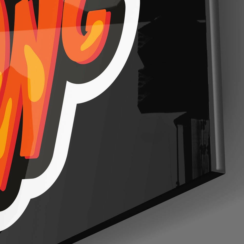 Close-up angled view of red and orange neon glass tubing with yellow accents forming stylized letters against dark background.