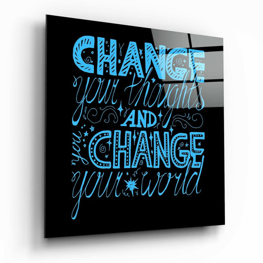 Angled 3D perspective view of black glass wall art with blue lettering reading "Change Your Thoughts And Change Your World.