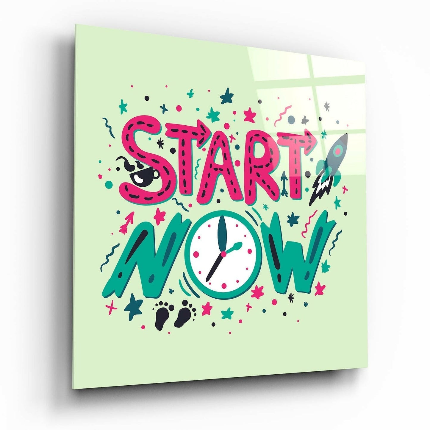 Square glass wall art with "START NOW" in pink letters and a teal clock on pale green background, angled perspective view.