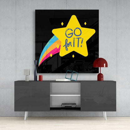 Yellow star glass wall art with "GO for IT" text and colorful rainbow trail displayed above gray media console in modern room setting.