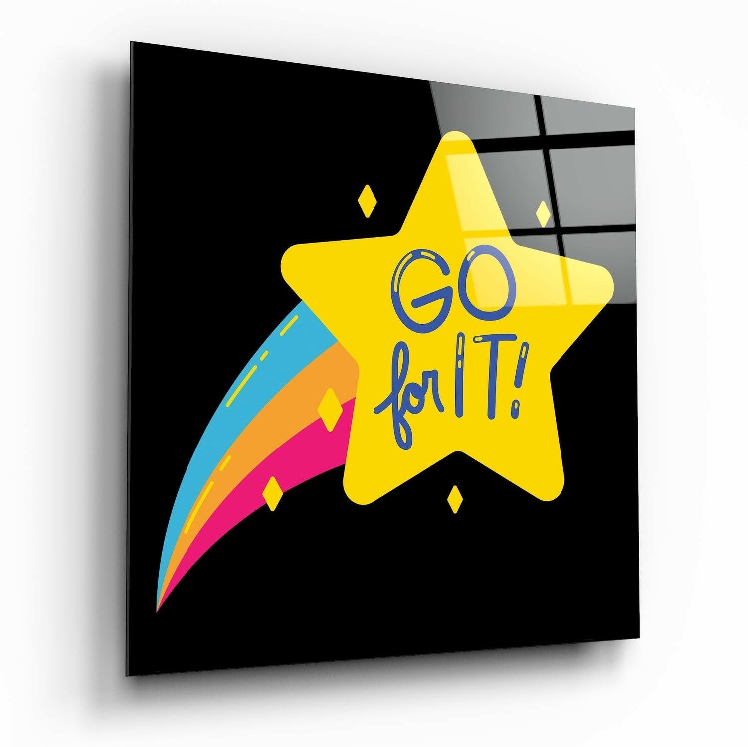 Angled perspective view of black glass wall art featuring a large yellow star with "GO for IT" text and a colorful comet trail.