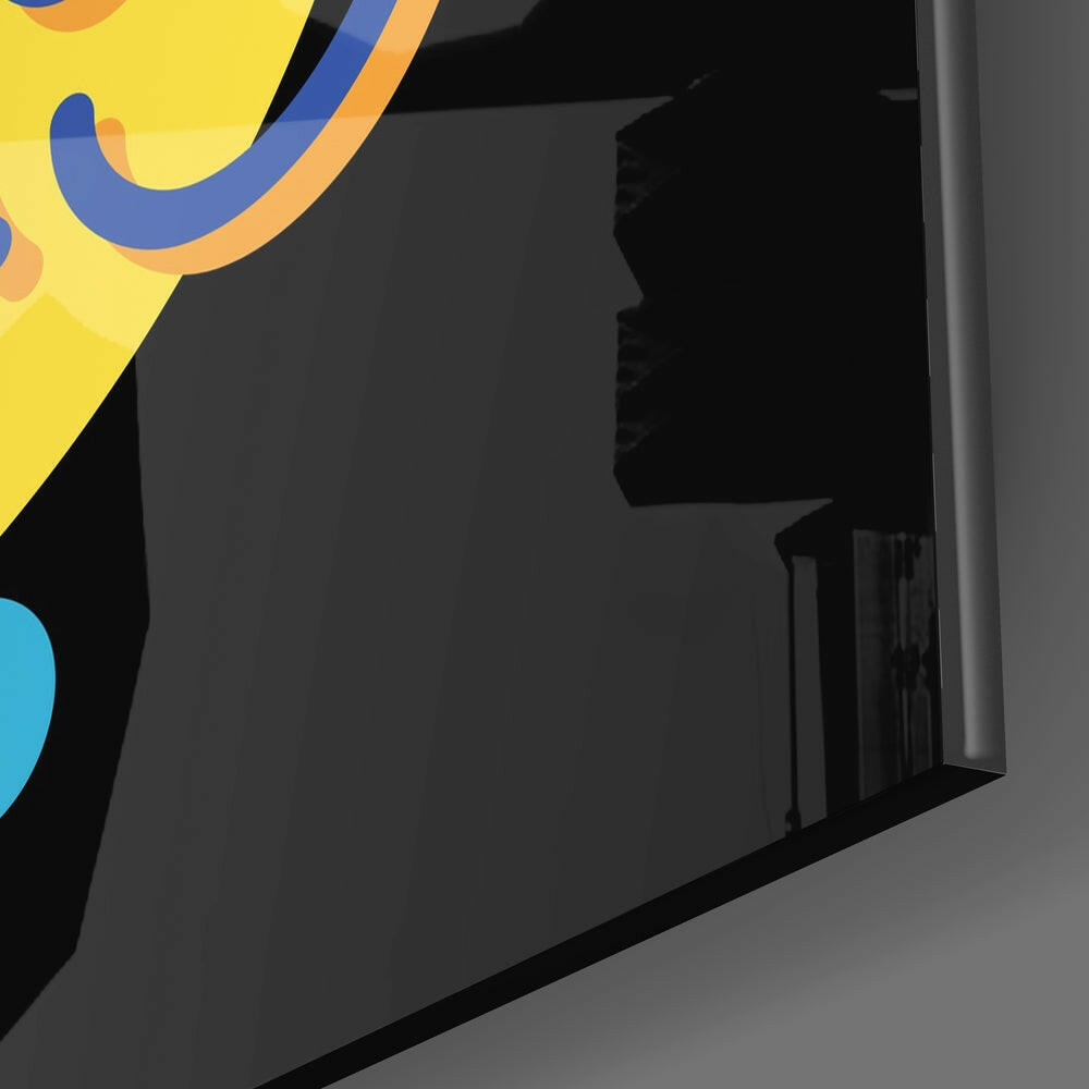 Close-up angled view of glass wall art showing colorful abstract design with yellow, blue, and cyan curved shapes against dark background.