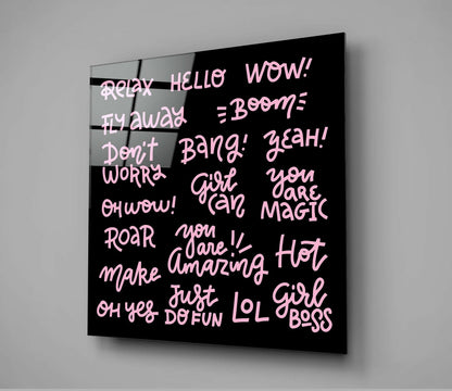 Black glass wall art panel with pink neon-style text displaying empowering phrases like "Girl Boss," "You Are Magic," and "Relax," mounted at an angle against gray wall.